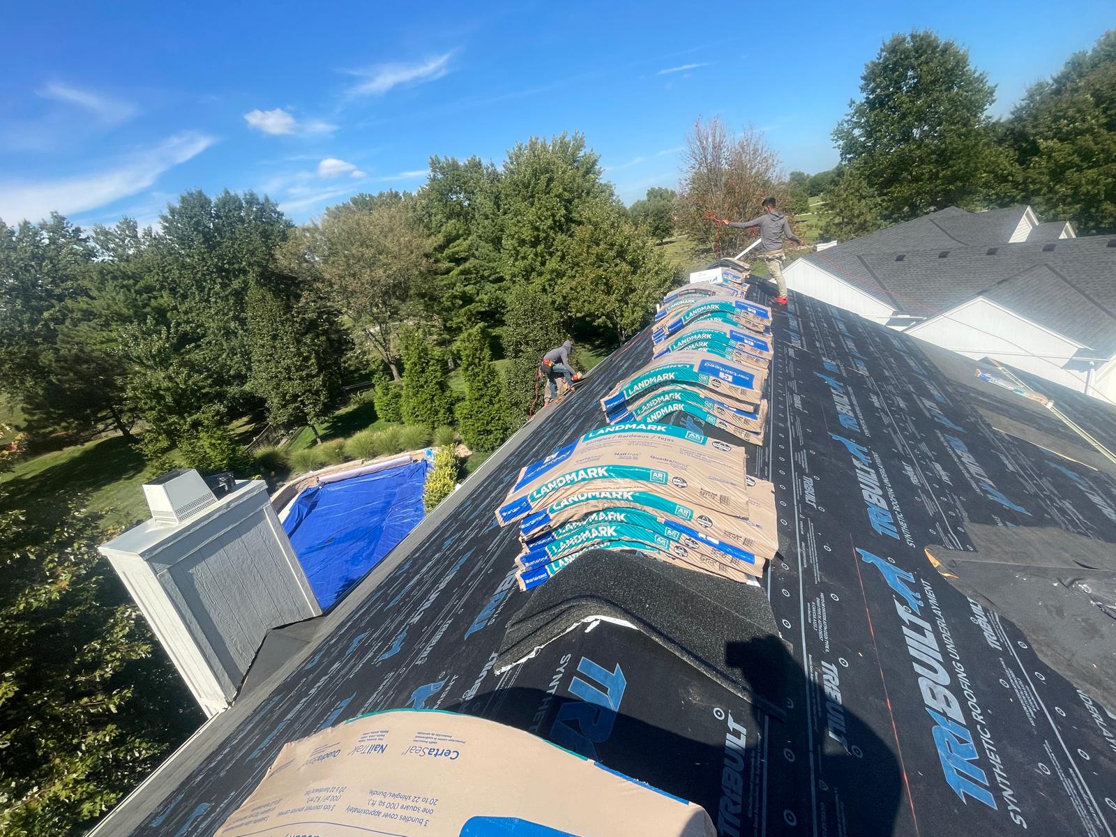 CertainTeed Landmark shingles staged on a roof ridge ready for installation